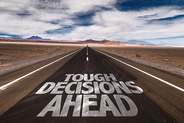 Tough Decisions Ahead written on desert road Tough Decisions Ahead written on desert road toughness stock pictures, royalty-free photos & images