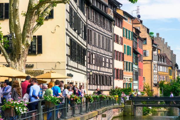 Tourism in Strasbourg, France Strasbourg, Bas-Rhin / France - May 27, 2012: Tourists on the banks of the Ill river in the city center bas rhin stock pictures, royalty-free photos & images