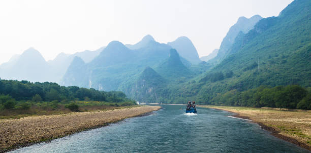 Tourist boats with tourists traveling along the Li river from Guilin to Yangshuo stock photo