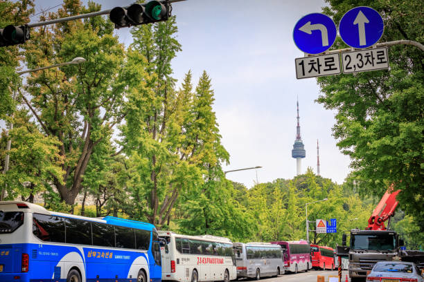 Tourist buses at Namsan Baekbeom Plaza behind N seoul tower on Jun 20, 2017 in Jung-gu, Seoul, South Korea Tourist buses at Namsan Baekbeom Plaza behind N seoul tower on Jun 20, 2017 in Jung-gu, Seoul city, South Korea jun xu stock pictures, royalty-free photos & images