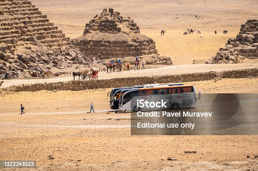 istock CAIRO, EGYPT - MAY 18 2021: tourist excursion bus of the tour operator Anex Tour, brought tourists to the pyramids of Giza. Tourism and travel in Egypt 1322241023
