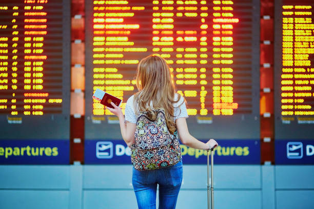 Tourist girl with backpack in international airport stock photo