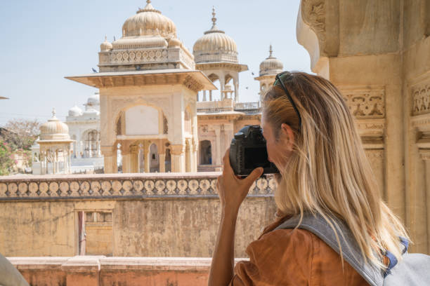 Tourist photographing ancient temple using camera, Jaipur, Rajasthan, India. People travel Asia concept stock photo