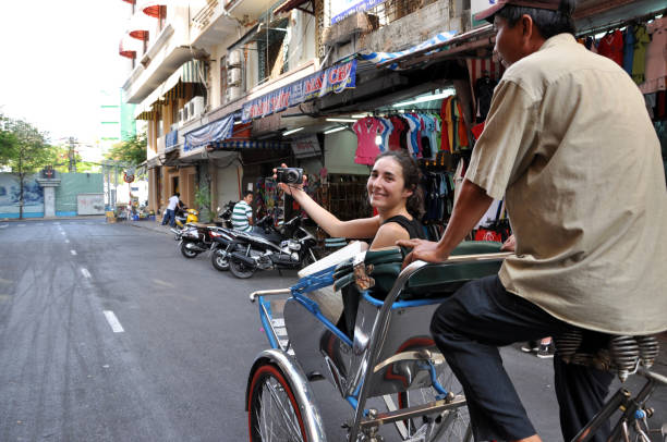 Tourist taking a tour with a classic Vietnamese rickshaw, tuk tuk stock photo