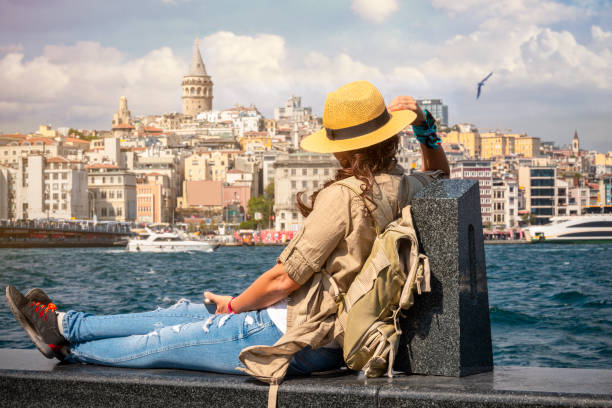 toeristische vrouw aan de kust van eminonu in istanboel. - galata stockfoto's en -beelden