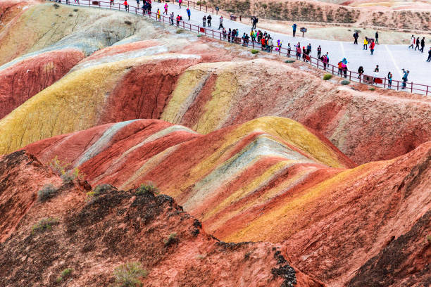 Tourists Admiring Rainbow Mountain, Gansu, China . Colorful Danxia landform. danxia landform stock pictures, royalty-free photos & images