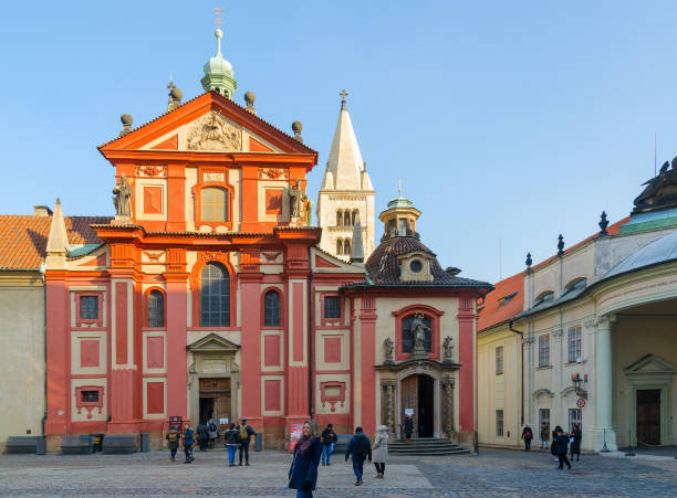 Tourists are near Basilica of St. George in Prague Castle stock photo