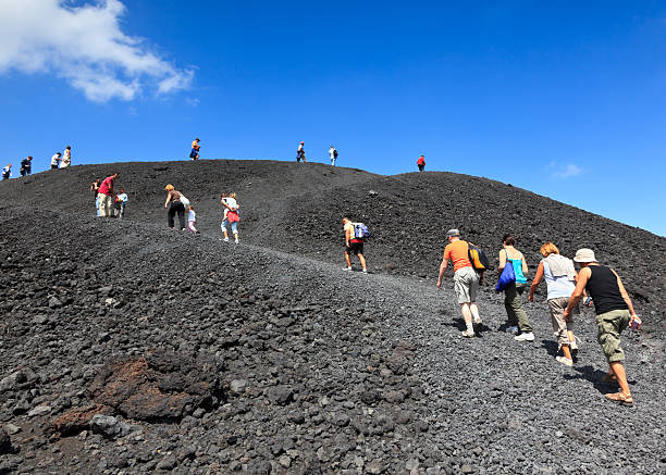 Tourists climbing Mt. Etna, Italy stock photo