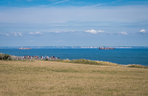 Tourists enjoying the view on container vessels passing through the Strait of Dover