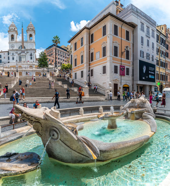 Tourists gather around the Fountain of the Boat at the Piazza di Spagnia stock photo