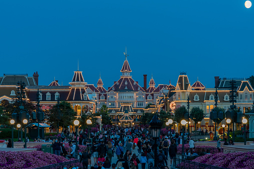 Paris, France - August 20th 2021: A crowd of tourists leaving Disneyland Park in Paris after closing at the end of the day