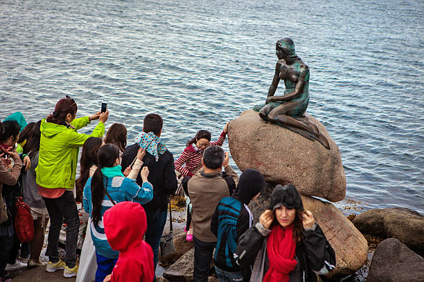 Tourists take pictures of the Little Mermaid stock photo
