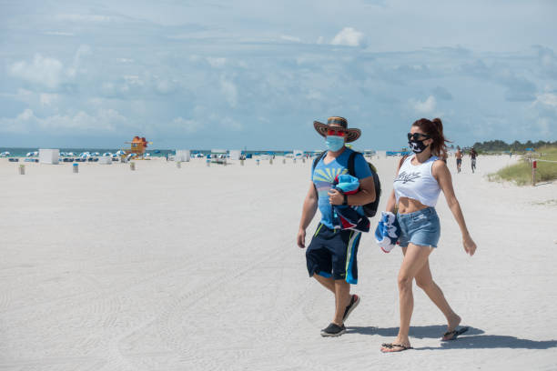 Tourists wear protective face masks in Miami Beach, Florida stock photo