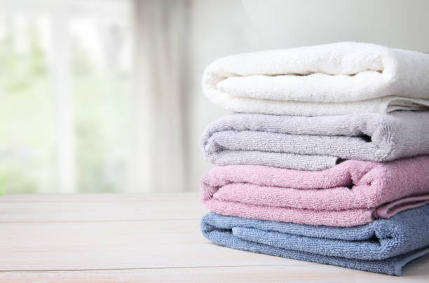 Towels stack on table empty space background. Colorful folded towels stack on table empty copy space. towel stock pictures, royalty-free photos & images