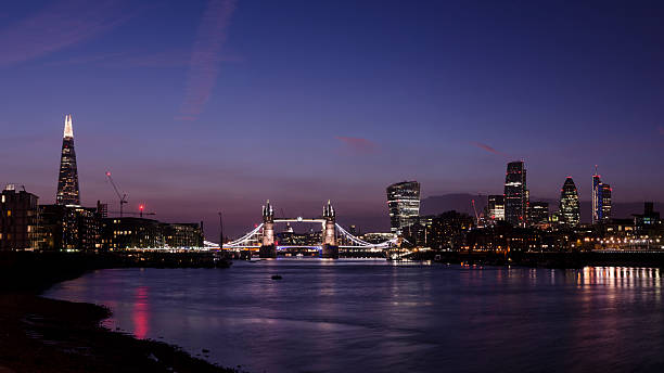 Tower Bridge and the London skyscraper skyline night panorama stock photo