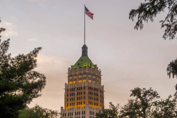 Tower Life Building at Dusk in Downtown San Antonio Texas This is a view of downtown San Antonio, Texas showing the Tower Life Building in the background at dusk on a fall evening.  This tall building is an iconic part of the San Antonio skyline. has san hawkins stock pictures, royalty-free photos & images