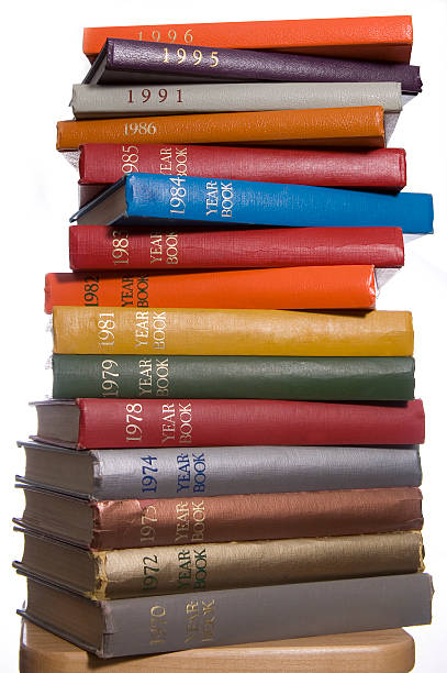tower of colorful yearbooks stock photo