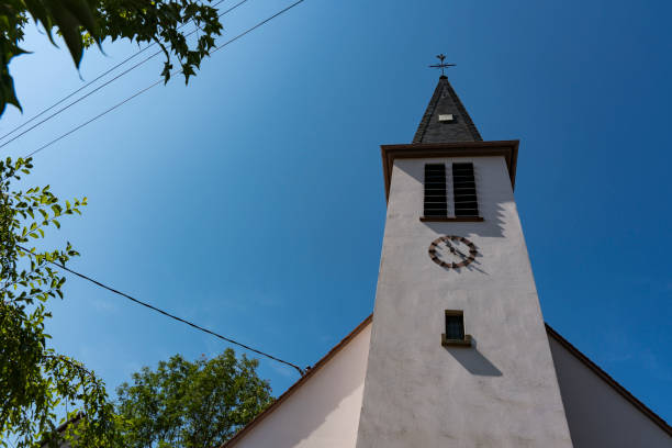 tower of white church in Ingolsheim, France church in Ingolsheim, France bas rhin stock pictures, royalty-free photos & images