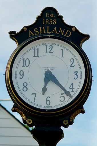 Ashland, Virginia, USA - June 5, 2022: Close-up of a large clock on a pedestal at the Ashland Train Station.
