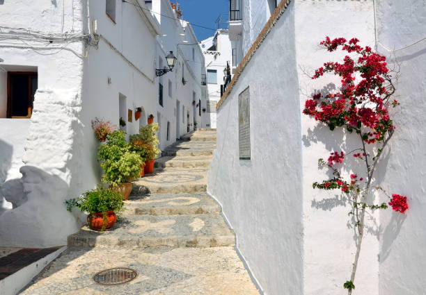 Townhouses along a typical whitewashed village street Townhouses along a typical whitewashed village street, Frigiliana, Andalusia nerja stock pictures, royalty-free photos & images