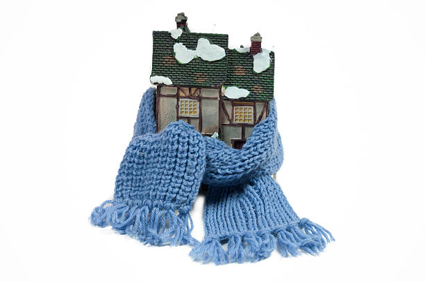 Toy half-timbered house wrapped in a shawl isolated stock photo