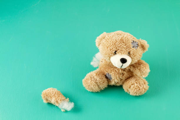 Toy teddy bear with teared away paw Toy teddy bear with teared away paw. Disappointment, spoiled life and ruined illusion concept broken doll 1 stock pictures, royalty-free photos & images