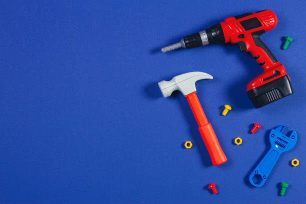 toys background. top view of toy tools on blue background - plastic hammers imagens e fotografias de stock