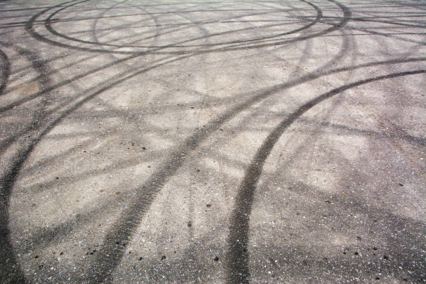 Traces of braking from rubber tyres on cement Traces of braking from rubber tyres on cement, black tire track skid mark skid mark stock pictures, royalty-free photos & images