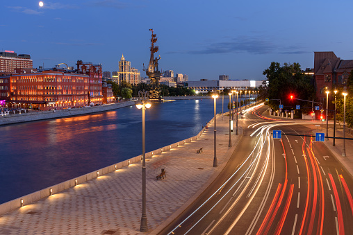 Traces of car headlights moving cars. Evening view of the embankment of the Moscow River.