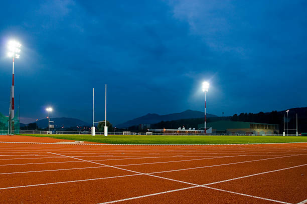 Track and Field Stadium at Night stock photo