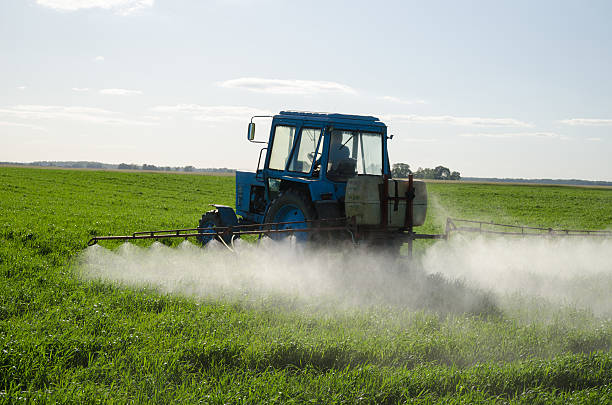 Tractor fertilize field pesticide and insecticide stock photo