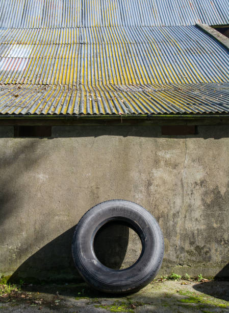 Tractor Tyre Against Barn Wall Stock Photo Download Image Now