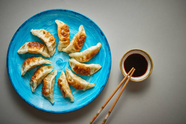 Traditional asian dumplings Gyozas on turqoise ceramic plate stock photo