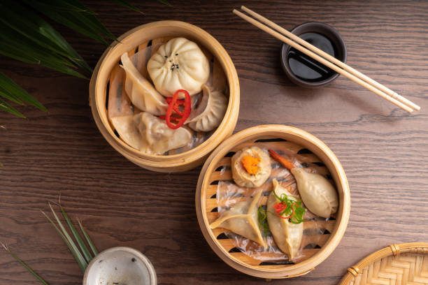 Traditional Asian food dumpling in a bowl Hot dish dim sum served in a national wooden bowl stock photo