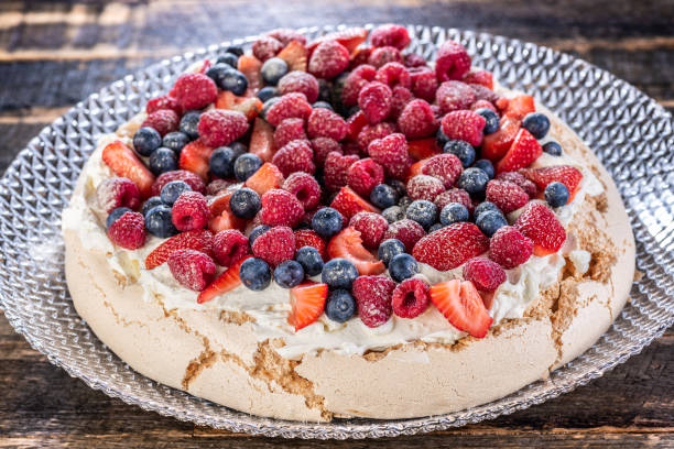 A traditional Australian desert, Pavlova featuring meringue whipped cream, strawberries, blueberries, raspberries A traditional Australian desert, Pavlova featuring meringue whipped cream, strawberries, blueberries, raspberries pavlova dessert photos stock pictures, royalty-free photos & images