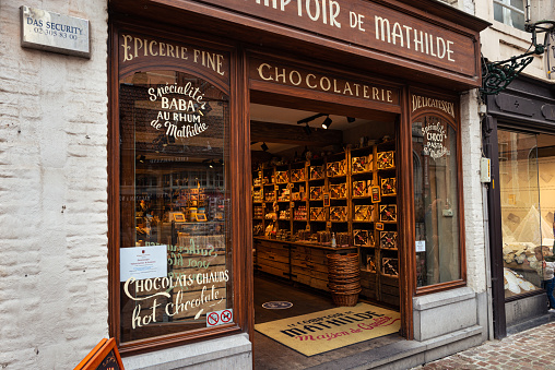 Brugge, Belgium - October 2021: Classic belgian chocolate store in the historic centre of Bruges, Belgium.