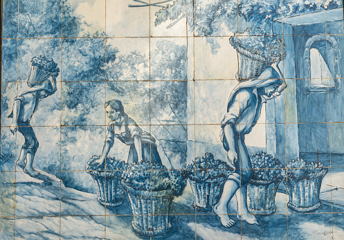 Funchal, Madeira, Portugal - September 1, 2016: Traditional ceramic tiles in  Funchal on Madeira depicting local life.