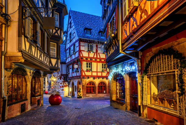 Traditional Christmas decorations and illumination in Colmar Old Town, Alsace, France Traditional colorful half-timber houses in Colmar Old Town, Alsace, France, decorated and illuminated for Christmas colmar stock pictures, royalty-free photos & images