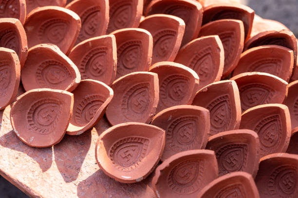 Traditional diya made of clay and mud placed in sunlight at factory in Rural India. Traditional diya made of clay and mud placed in sunlight at factory in Rural India. Diya used to lit home on the occasion of Diwali and other festivals. chhath stock pictures, royalty-free photos & images