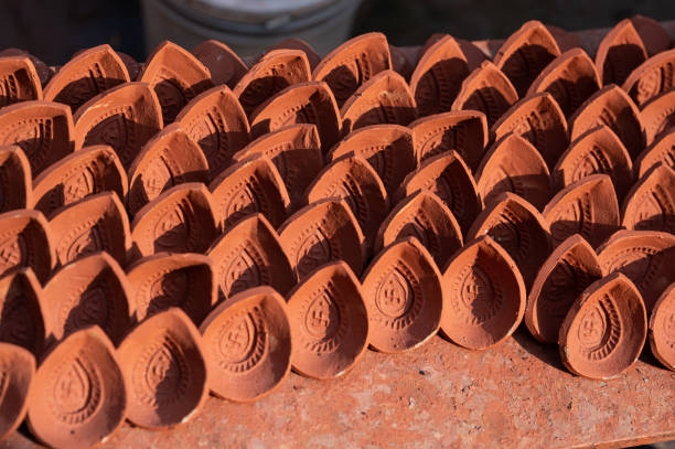 Traditional diya made of clay and mud placed in sunlight at factory in Rural India. Traditional diya made of clay and mud placed in sunlight at factory in Rural India. Diya used to lit home on the occasion of Diwali and other festivals. chhath stock pictures, royalty-free photos & images