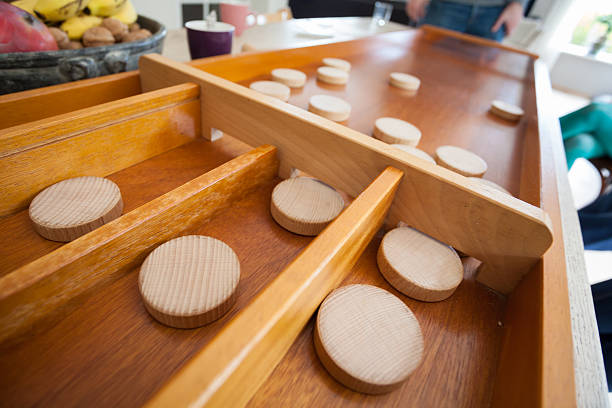 traditional dutch game called 'sjoelen'. the wooden disks hove - sjoelen stockfoto's en -beelden