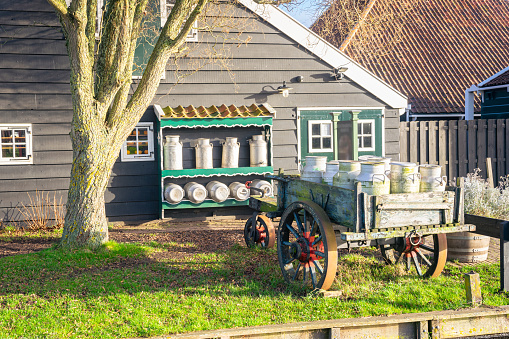 Scenic view of a cart with milk cans at a Dutch farm.