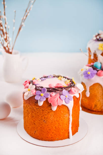 Traditional Easter cake sweet bread kulich decorated with candies. sugar flower, meringue icing stock photo