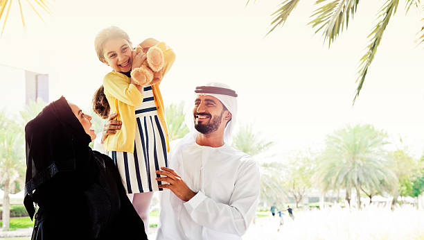 Traditional Emirati young family enjoying weekend. stock photo