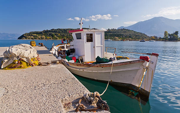 Traditional Greek fishing boat in Archaia Epidaurus harbor, Greece stock photo