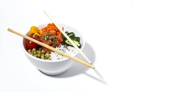 Traditional homemade asian salmon poke bowl with fresh vegetables. Healthy food stock photo