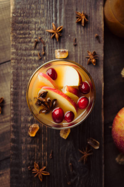 Traditional hot apple cider. Christmas drink with apples cinnamon, cranberry and anise. Homemade apple cider. Selective focus. Shallow depth of field. stock photo