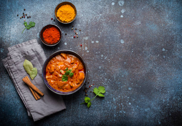 Traditional Indian dish curry Chicken tikka masala with spicy curry meat served in rustic ceramic bowl, popular Indian dish, on concrete background, top view and space for text bowl photos stock pictures, royalty-free photos & images