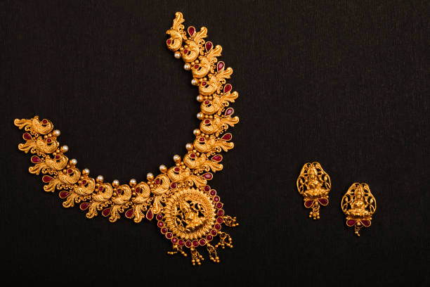 Traditional Indian Gold Necklace With Earrings Traditional Indian Gold Necklace With Earrings on black background. indian jewelry stock pictures, royalty-free photos & images