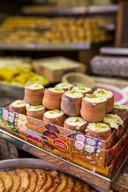 Traditional indian sweet Ask Forehead Vrindavan, India - March 16, 2016: Traditional indian sweet Minta Dahi in clay pots on street of Vrindavan, India mithai stock pictures, royalty-free photos & images